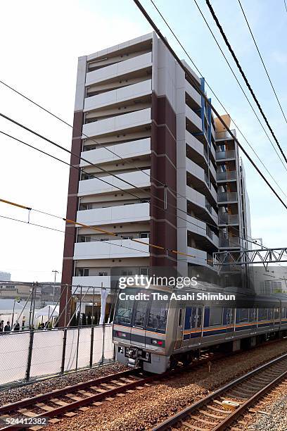 West train runs past the accident site on the eleventh anniversary of the train derailment accident on April 25, 2016 in Amagasaki, Hyogo, Japan. The...