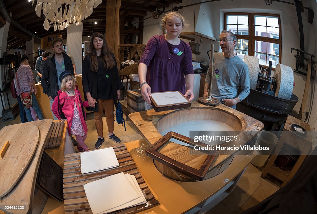 Pulp Vat A visitor makes a sheet of paper at a paper pulp vat in the Basel ...