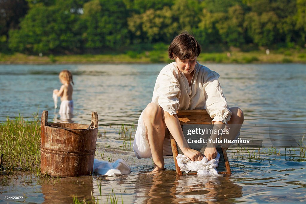 Mother and daughter washing laundry