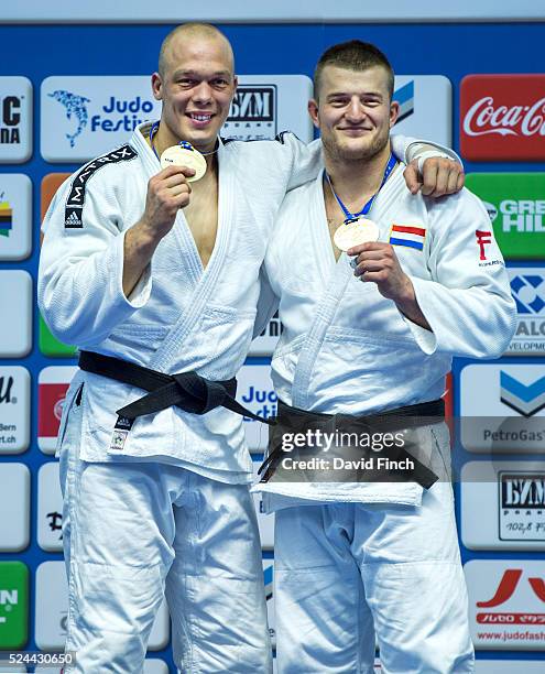 Henk Grol of Holland, left, smiles broadly as he shows his third European gold medal at u100kg alongside fellow Dutchman, Michael Korrell who claimed...