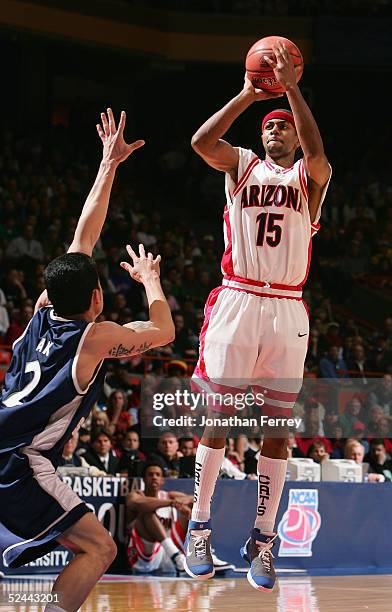 Mustafa Shakur of the Arizona Wildcats puts up a shot over David Pak of the Utah State Aggies during the 2005 NCAA division 1 men's basketball...