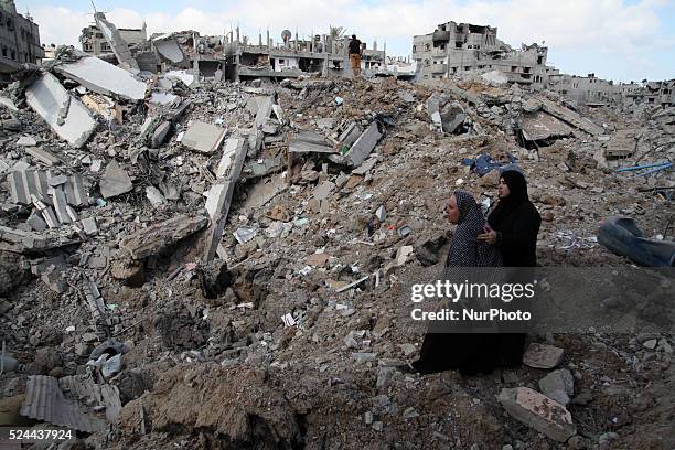 Palestinians inspect destroyed houses in the Shejaia neighbourhood, which witnesses said was heavily hit by Israeli shelling and air strikes during...