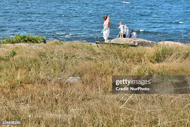 Denmark, Bornholm Island Pictures taken between 1st and 5th August 2014. Pictured: Rocky coast of the Allinge city at the Baltic Sea. Young family...