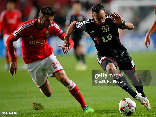 Benfica's midfielder Bryan Cristante vies for the ball with Leverkusen's forward Karim Bellarabi during the Champions League football match between...
