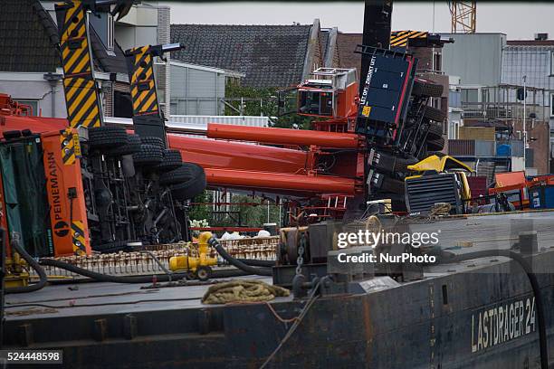 Aug. 6, 2015 - Two large cranes carrying a part of a bridge weighing 190 tons slid of a pontoon and crashed into several houses along the canal. The...