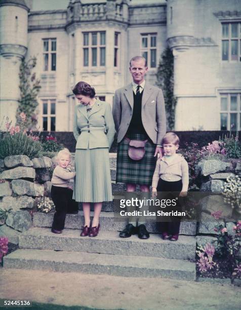 Queen Elizabeth II and The Prince Philip, Duke of Edinburgh with their two young children, Princess Anne and Prince Charles outside Balmoral Castle,...