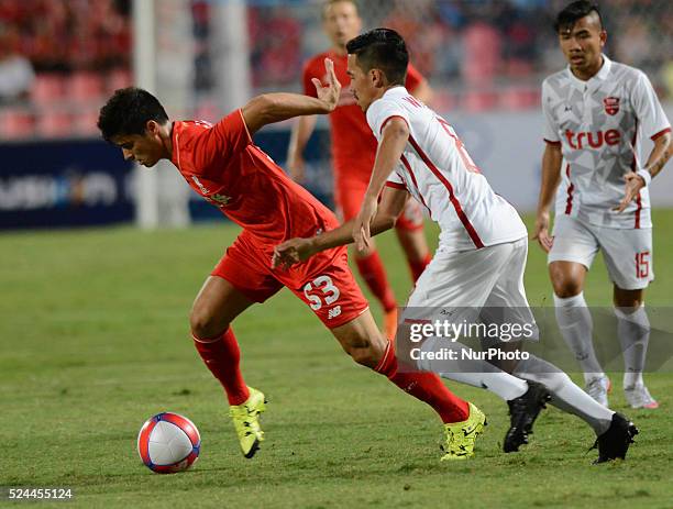 Joao Carlos Teixeira of Liverpool is closed down Wittaya Madlam of True Thai Premier League All Stars by during their international friendly match at...