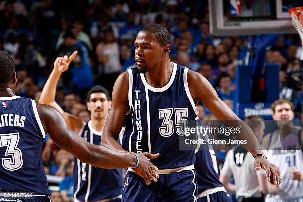 Kevin Durant of the Oklahoma City Thunder shakes his teammates hands in Game Three of the Western Conference Quarterfinals against the Dallas...