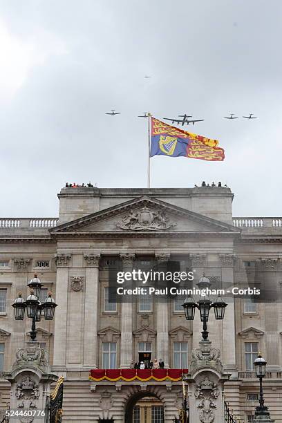 Queen Elizabeth II and the Royal family watch the flypast of Spitfire and Wellington Bomber aircraft from the balcony of Buckingham Palace to...