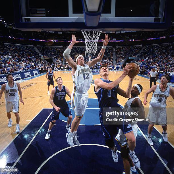 Andrei Kirilenko of the Utah Jazz goes to the basket past Chris Andersen of the New Orleans Hornets during the game at New Orleans Arena on March 4,...