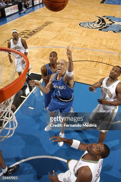 Doug Christie of the Orlando Magic shoots against the New Orleans Hornets during a game at TD Waterhouse Centre on February 13, 2005 in Orlando,...