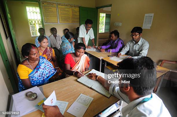 Women members of Village Financial Services Pvt Ltd, which is joint liability group for sustainable development, gather to complete formalities of...