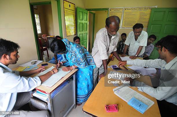 Women members of Village Financial Services Pvt Ltd, which is joint liability group for sustainable development, gather to complete formalities of...