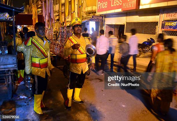 Members of an Indian wedding band play brass instruments,have tea during a religious procession ahead of Dussehra festival processi in the old city...