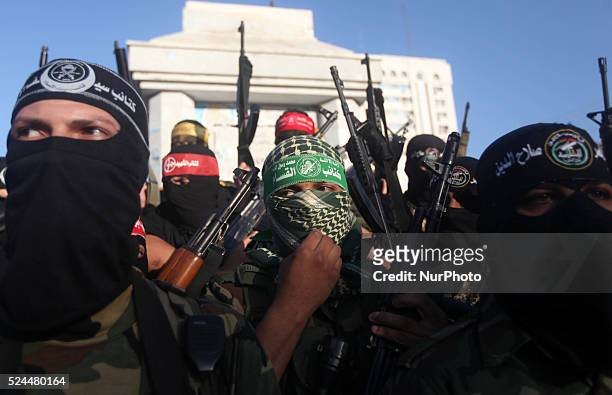 Palestinians militants from various armed factions, including Hamas, attend a news conference in Gaza City June 17, 2014. The news conference was...