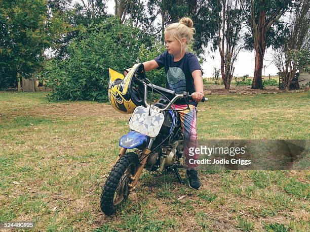 young girl sitting on small motorcycle outside - jodie griggs stock pictures, royalty-free photos & images