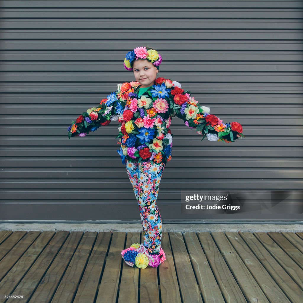 Child wearing home-made costume covered in flowers