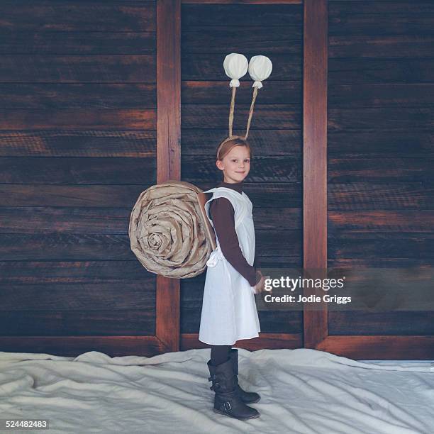 happy child wearing home-made snail costume - representação de animal imagens e fotografias de stock