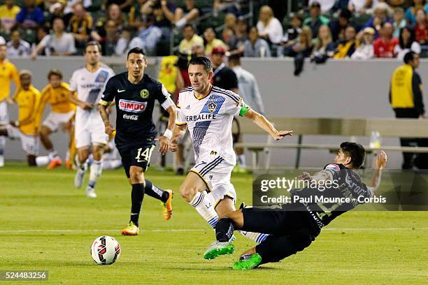 Robbie Keane of the Los Angeles Galaxy makes a play on Erik Pimentel of Club America during the Los Angeles Galaxy vs Club America match of the...