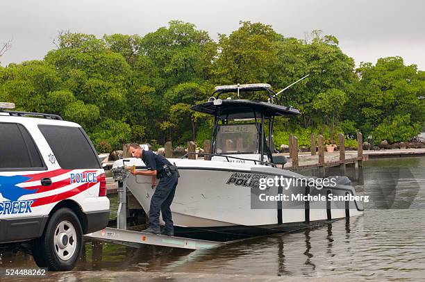 August 25, 2012 OFFICER MARTINEZ AND OFFICER SULLIVAN of station Indian Creek, remove a police boat from the water as Florida prepares for Hurricane...