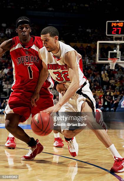 Francisco Garcia of the Louisville Cardinals drives against Tiras Wade of the Louisiana-Lafayette Ragin' Cajuns in the first round of the NCAA...