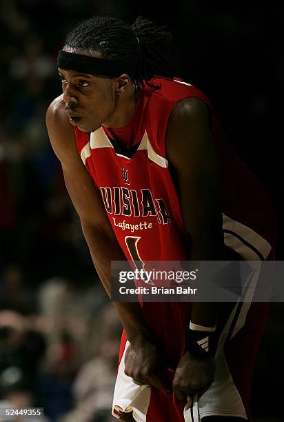 Taquan Dean of the Louisiana-Lafayette Ragin' Cajuns rests during a stoppage in play against the Louisville Cardinals in the first round of the NCAA...