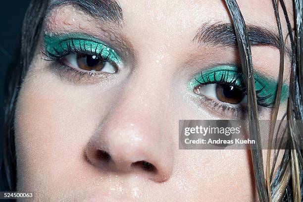 close up of young woman's eyes and wet skin. - eyeshadow stock-fotos und bilder