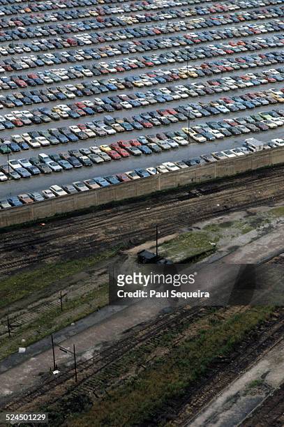 Aerial view of a full parking lot, next to train tracks, Chicago, Illinois, 1980s.