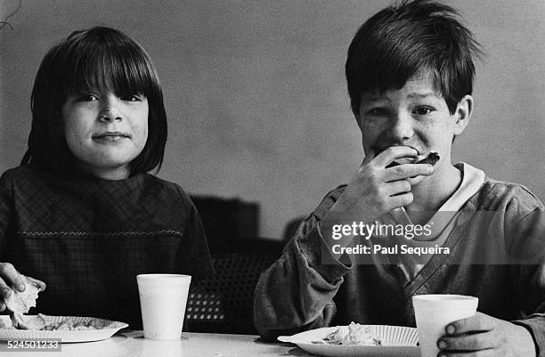 Two children eat at a Young Patriot Organization breakfast for children program, in the Uptown neighborhood, Chicago, Illinois, 1969. The YPO program...