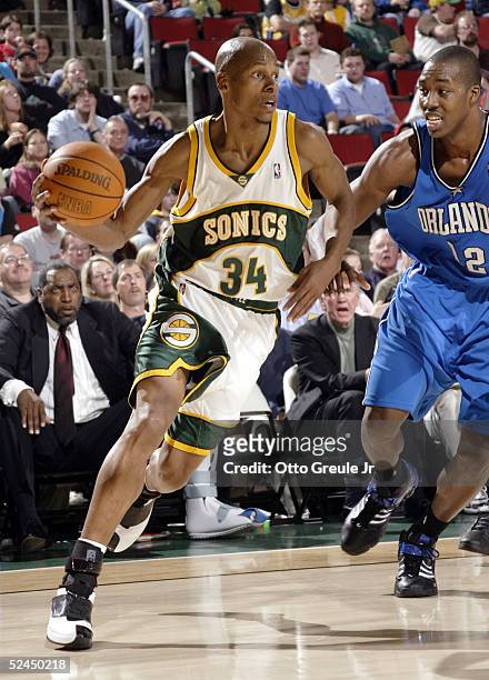 Ray Allen of the Seattle SuperSonics drives against Dwight Howard of the Orlando Magic on March 18, 2005 at Key Arena in Seattle, Washington. The...