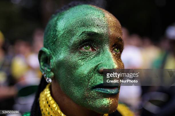 Demonstrators wears contact lenses with the format and the colors of the Brazilian flag during a protest against the president Dilma Rousseff that...