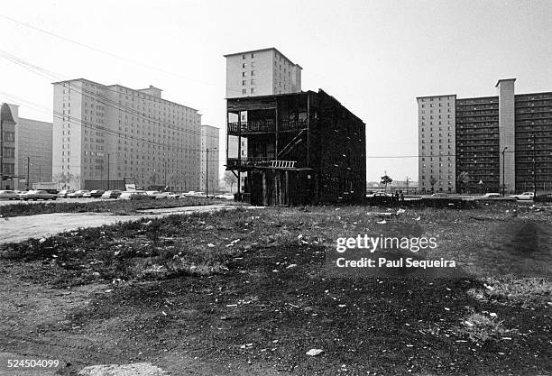 View of abandoned lots, a dilapidated apartment, and the Robert Taylor Homes in a south side neighborhood, Chicago, Illinois, 1960s.