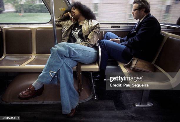 Scene inside one of the city's elevated trains, with two passengers seated by the window, Chicago, Illinois, late 1970s or early 1980s.