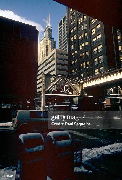 View looking up at the Willis Towers, formerly the Sears Towers, and a segment of the elevated subway tracks, in the downtown Loop neighborhood,...