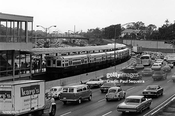 Rush hour scene on the Kennedy Expressway near Addison street shows a large number of cars traveling on the road, with the CTA train running along...