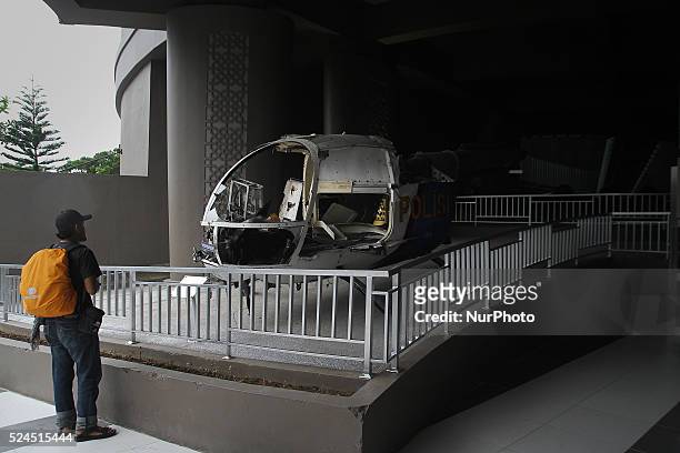 Visitors look at a police helicopter was damaged by the 2004 Indian Ocean tsunami and now preserved ahead of the 10th anniversary at the Tsunami...