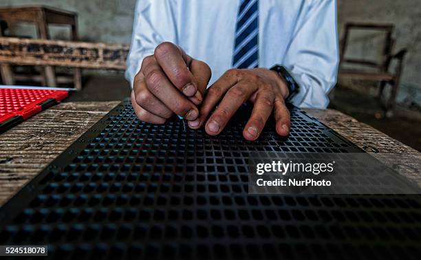 Blind, learns Braille writing at Abhedananda Home, a school for deaf, dumb and blind students on September 01, 2015 in Srinagar, the summer capital...