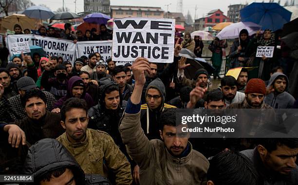 Kashmiri contractual teacher holds a placard during a protest demonstration on 18, 2015 in Srinagar, the summer capital of Indian administered...