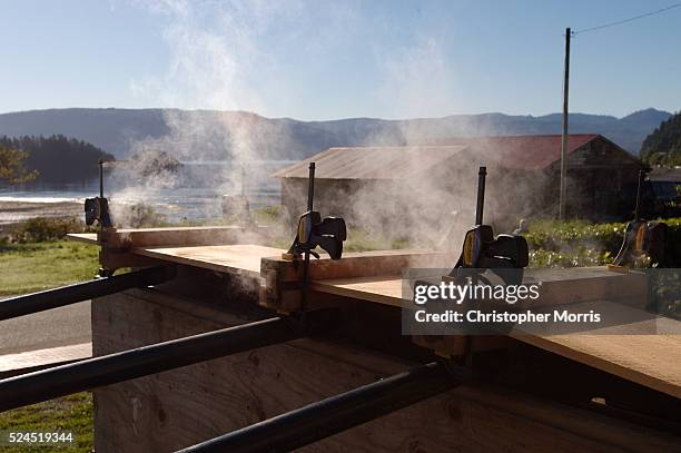 Steaming a cedar plank makes it pliable for making bentwood boxes. The boxes will then be used in a burial ceremony, laying to rest the remains of...