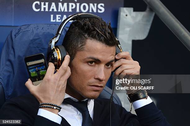 Real Madrid's Portuguese forward Cristiano Ronaldo sits in the dug-out ahead of kick off of the UEFA Champions League semi-final first leg football...