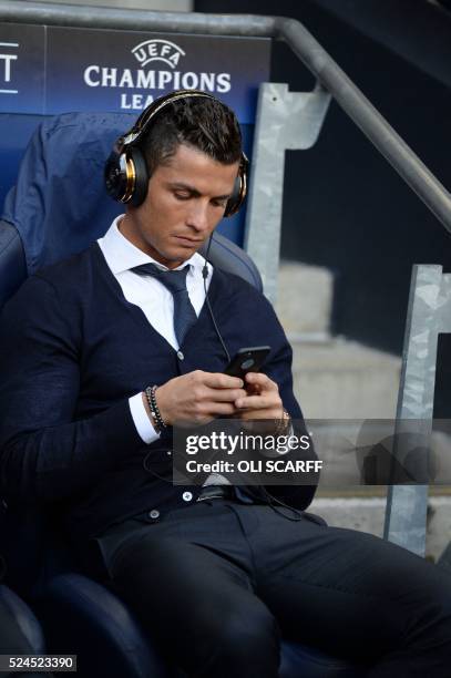 Real Madrid's Portuguese forward Cristiano Ronaldo sits in the dug-out ahead of kick off of the UEFA Champions League semi-final first leg football...