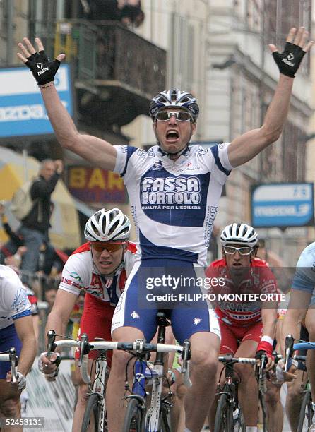 Alessandro Petacchi of Italy jubilates after crossing the finish line and winning the 96th Milano Sanremo classic cycling race, 19 March 2005 in...