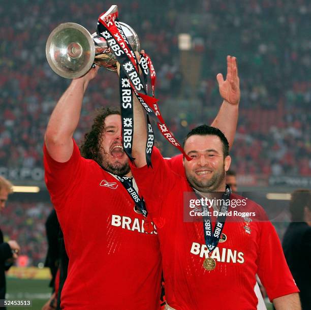 Adam Jones and Mefin Davies hold the trophy aloft as Wales win the Grand Slam after defeating Ireland in the RBS Six Nations International between...