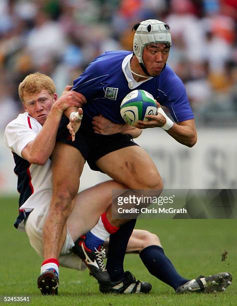 Young- Nam You of Korea in action against the USA on day two of the Rugby World Cup Sevens held at Hong Kong Stadium March 19, 2005 in Hong Kong,...