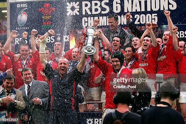 Gareth Thomas and Michael Owen hold aloft the trophy after winning the Grand Slam by beating Ireland in the RBS Six Nations International between...