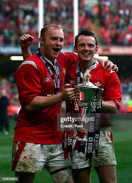 Martyn Williams and Kevin Morgan hold aloft the trophy after winning the Grand Slam by beating Ireland in the RBS Six Nations International between...