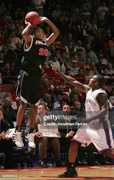 David Doubley of the Pacific Tigers puts up a shot over Nate Robinson of the Washington Huskies during the 2005 NCAA division 1 men's basketball...