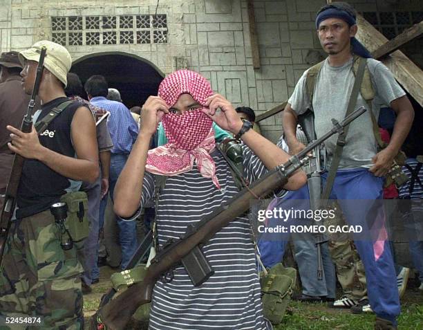 Dated 27 May 2000 file picture shows Al-Qaeda linked Abu Sayyaf gunmen guard a mosque in Bandang village, Jolo island where their leaders and group...