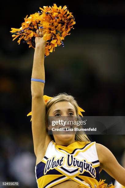 Cheerleader of the West Virginia Mountaineers cheers as her team takes on the Wake Forest Demon Deacons during the second round of the 2005 NCAA...