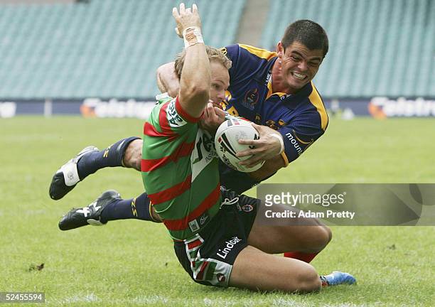 Luke MacDougall of the Rabbitohs goes in for a try while Daniel Wagon of the Eels misses the tackle during the NRL round 2 match between the South...